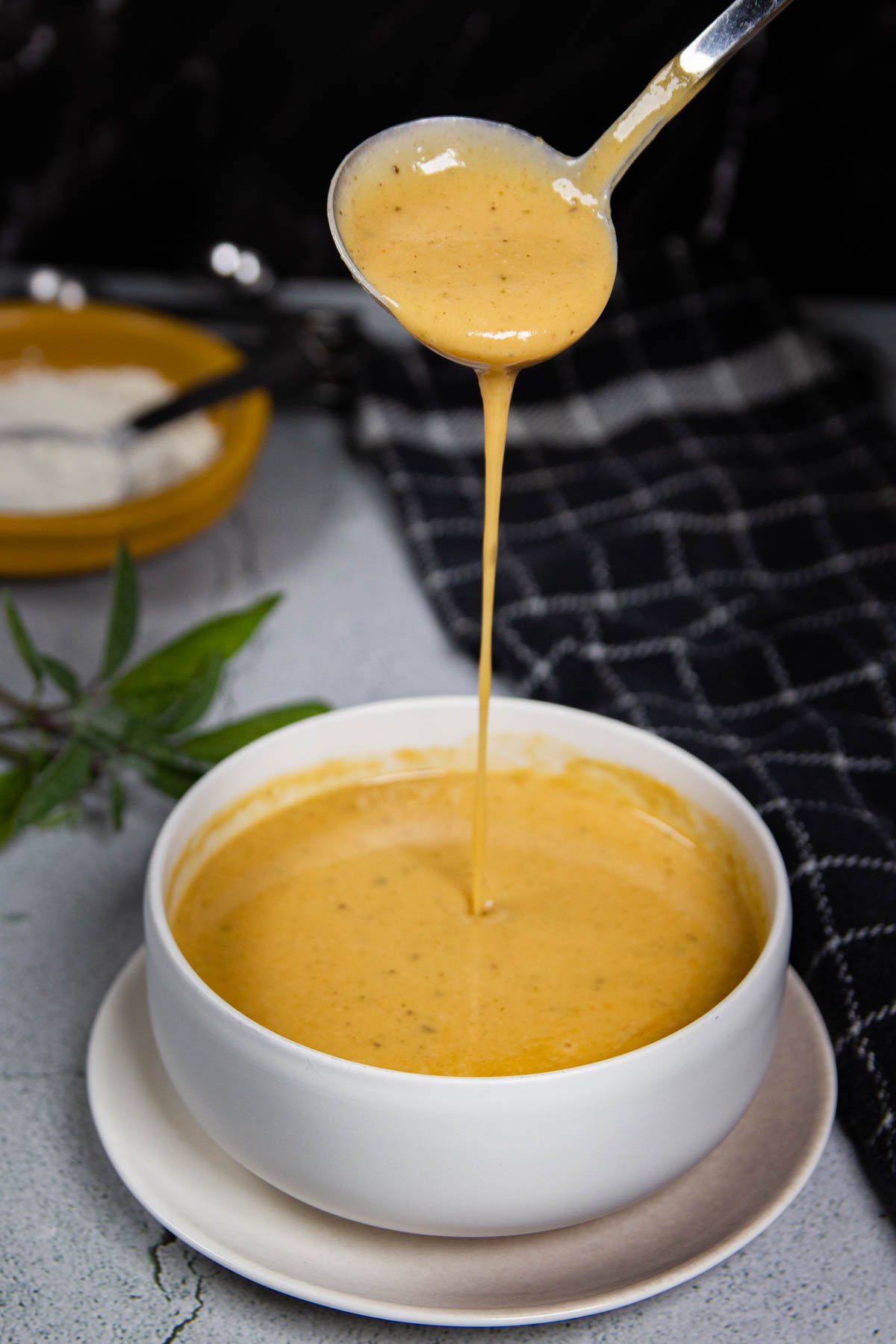 Pouring the brown butter gravy into a sauce boat.