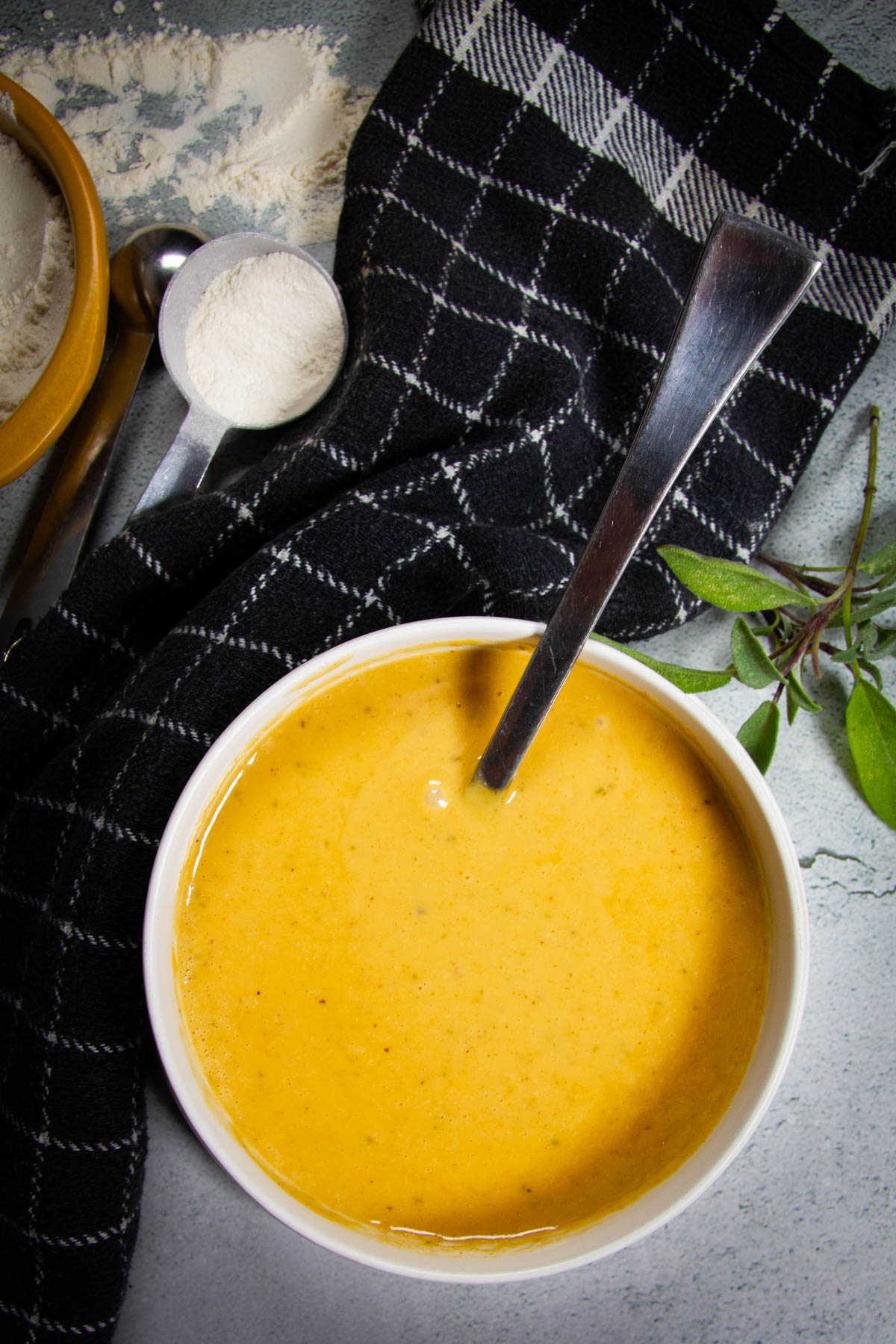 Brown butter gravy in a bowl on a table.