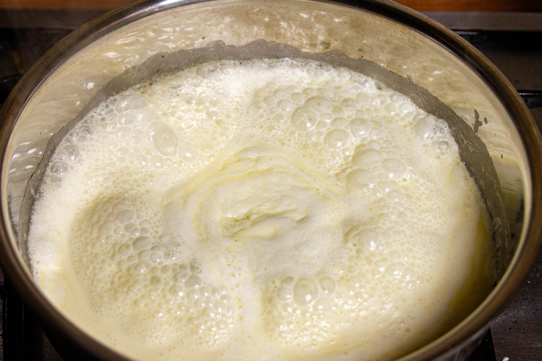 Heating the cream and butter together in a pan.