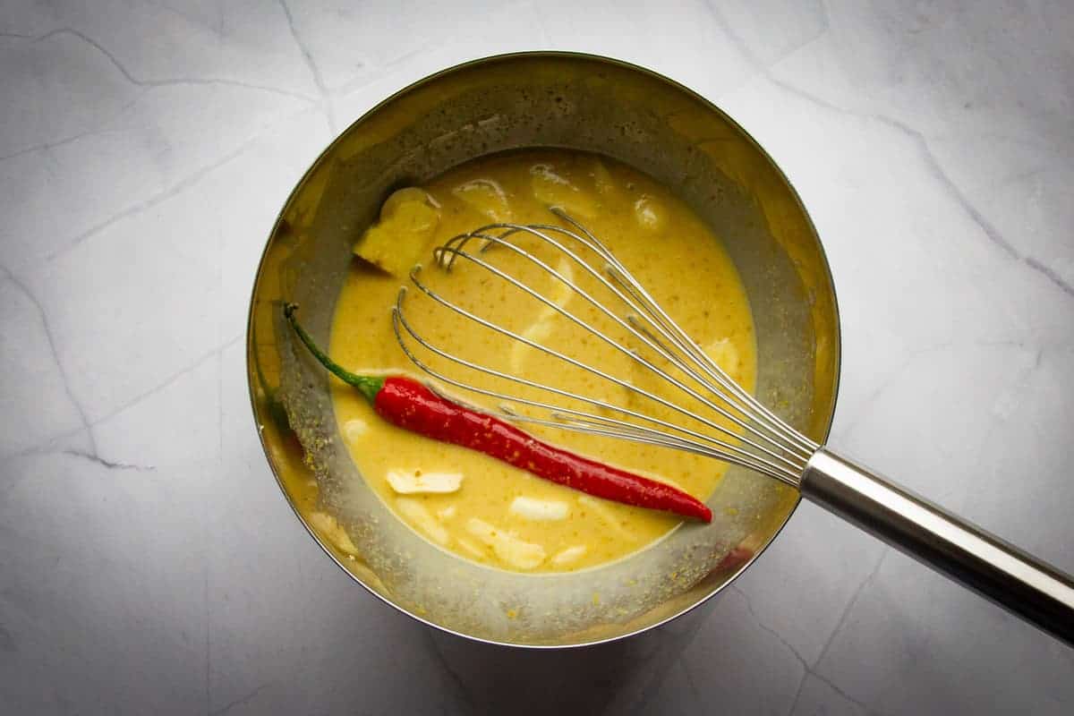Whisking the marinade in a bowl.