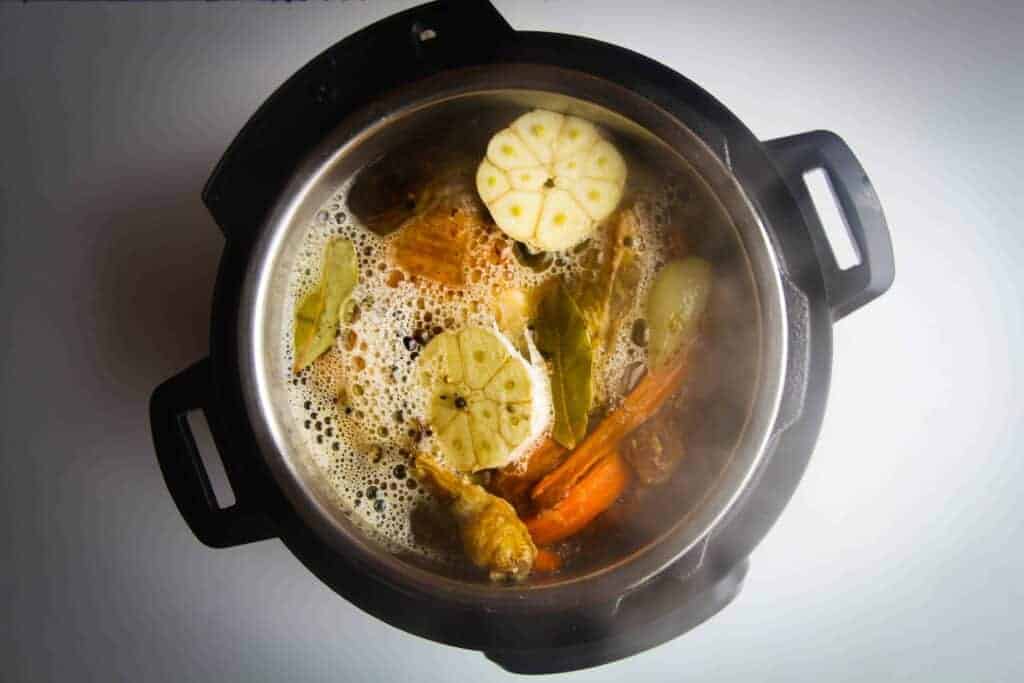 The stock simmering in the instant pot.