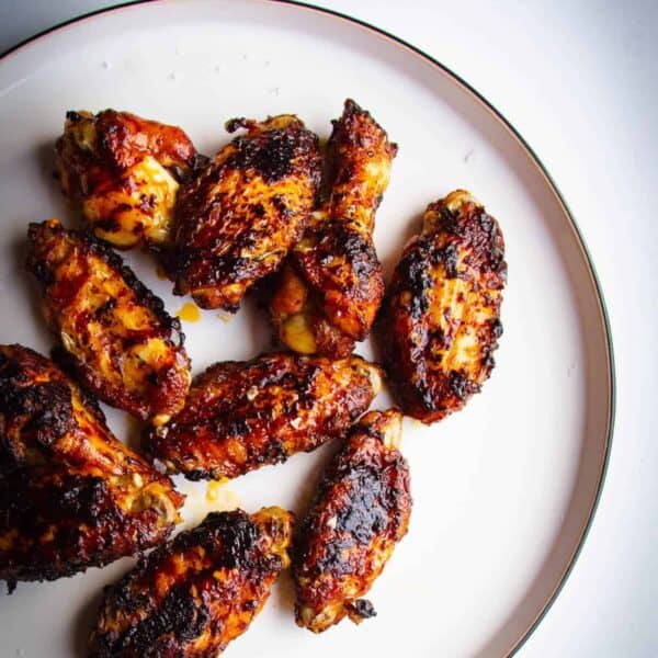 Marmite and chili chicken wings on a plate.