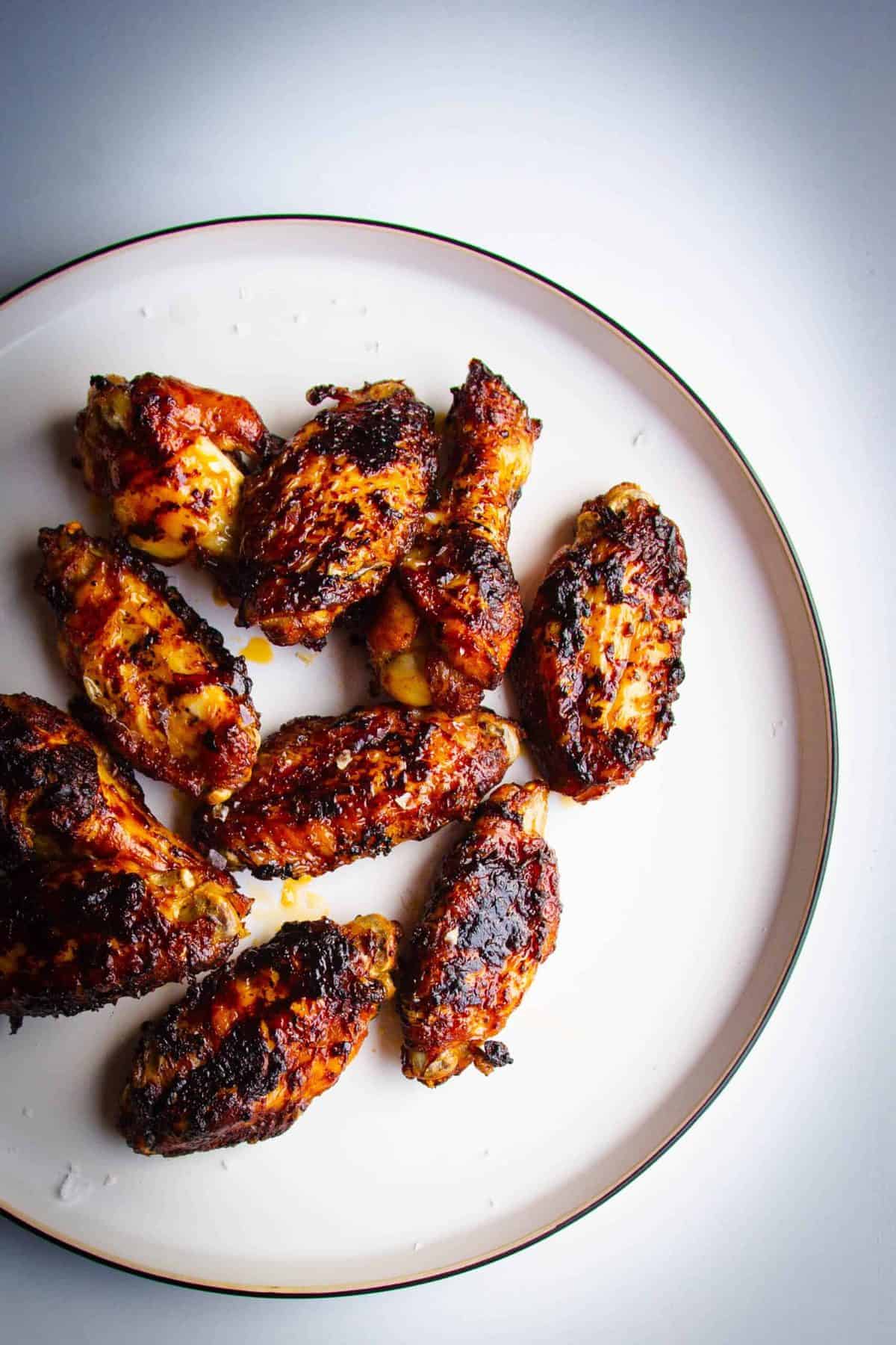 Marmite and chili chicken wings on a plate.
