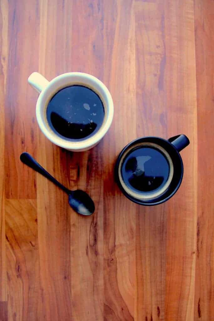 Two french press cups of coffee.