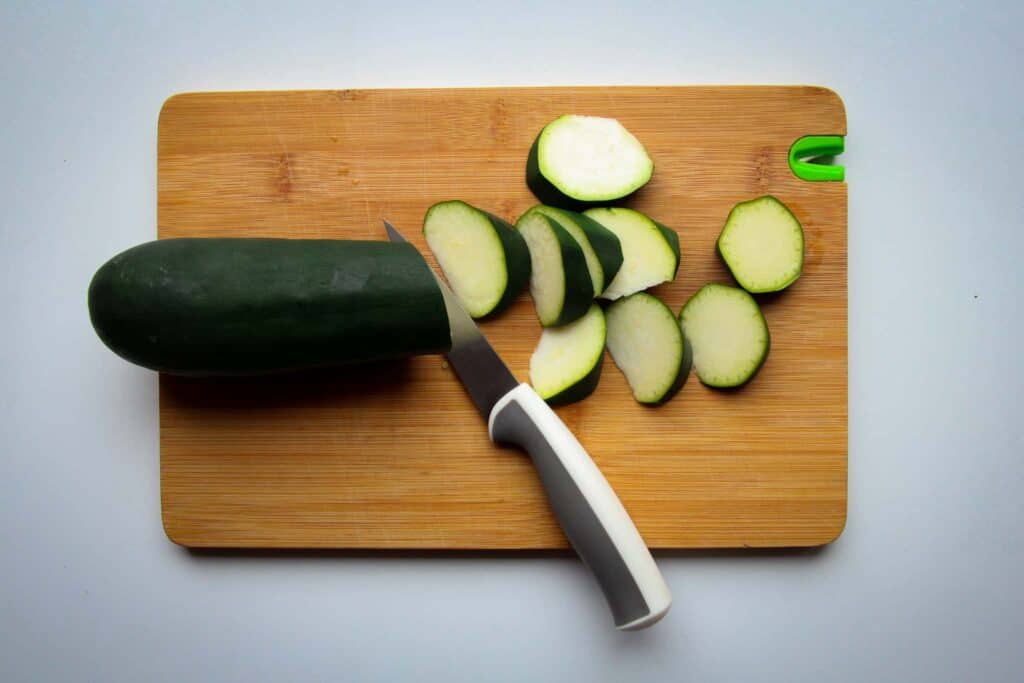 Cutting the courgette into pieces.