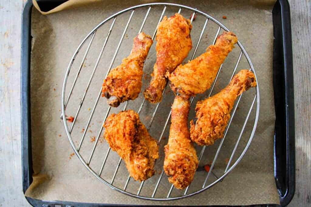 Crispy buttermilk fried chicken on a resting rack.