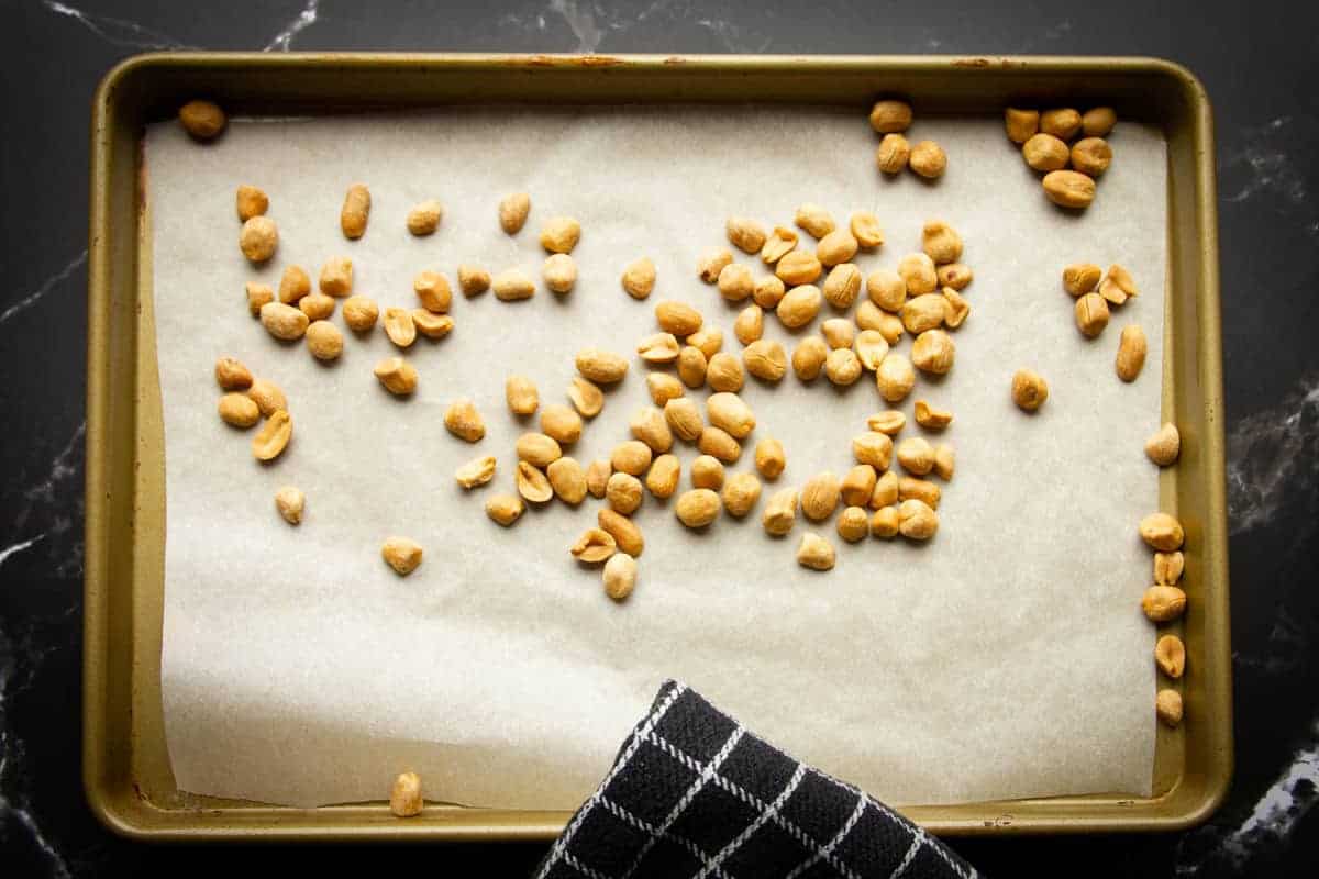 Roasting the peanuts in the oven until golden brown.