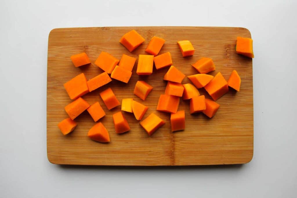 Butternut squash diced up on a cutting board.