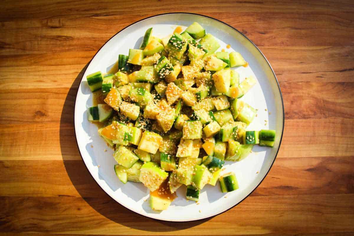 Crunchy apple cucumber salad with miso and sesame on a plate.