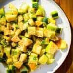 Crunchy apple cucumber salad with miso and sesame on a plate.