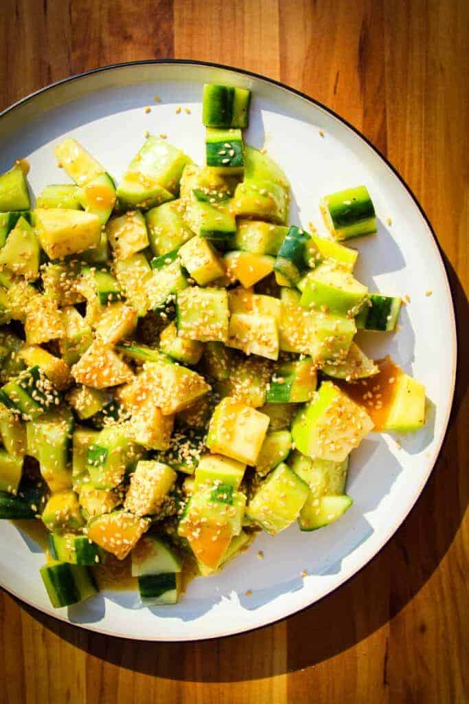 Crunchy apple cucumber salad with miso and sesame on a plate.