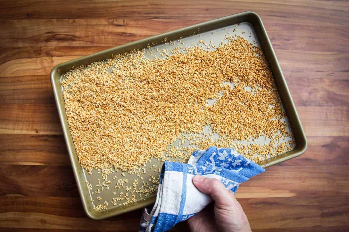 Toasting the sesame seeds on a tray.