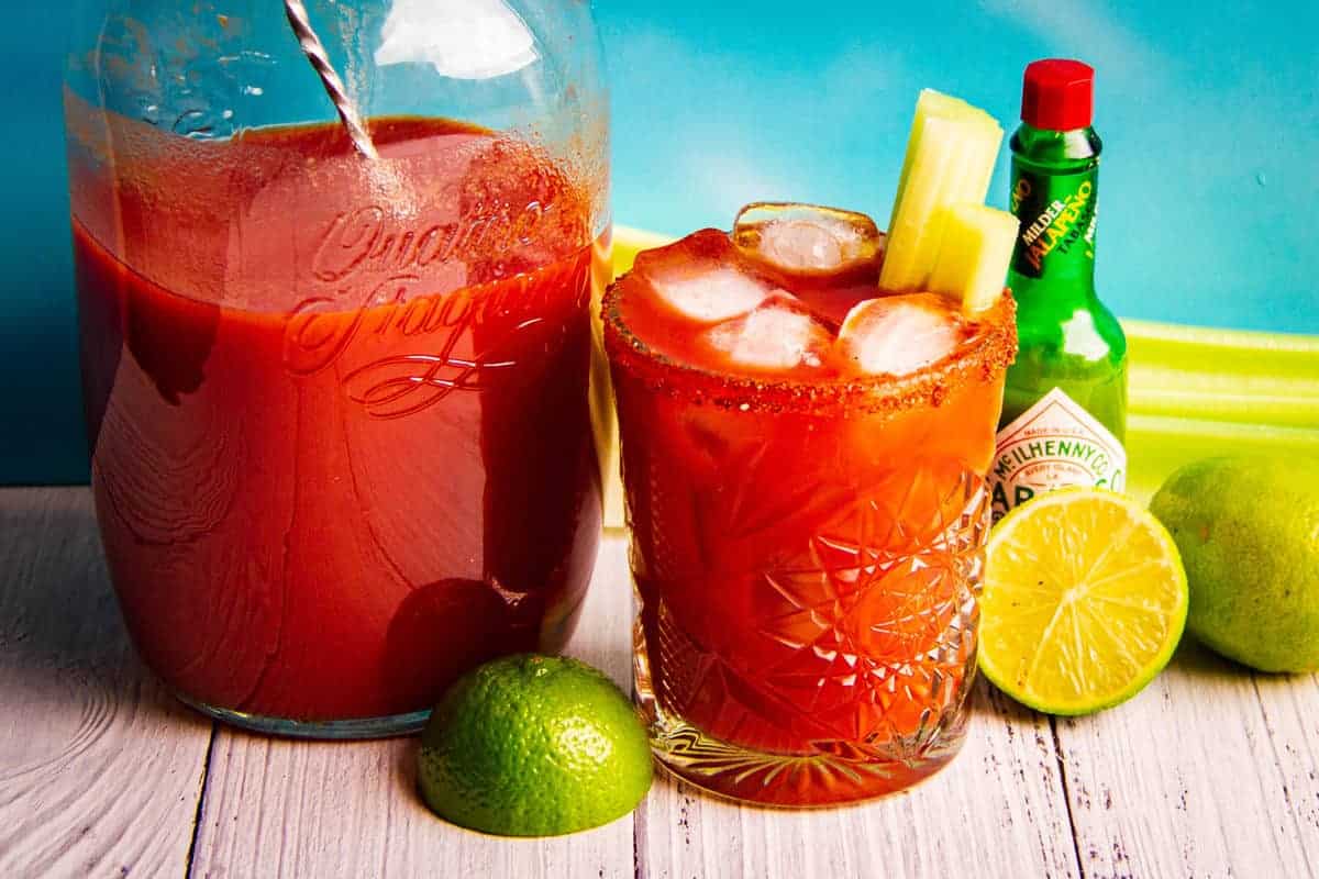 A bbq bloody mary cocktail with celery and lime.
