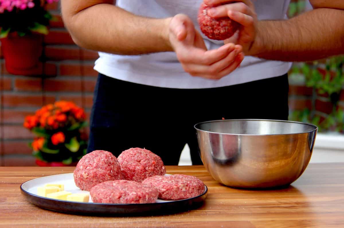 Shaping the burgers in to patties.