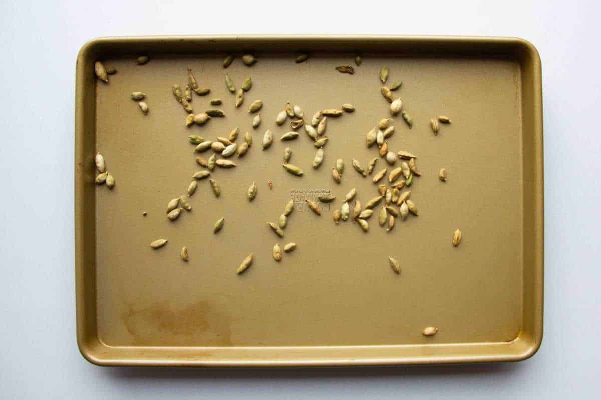 Cardamom seeds toasted on a tray