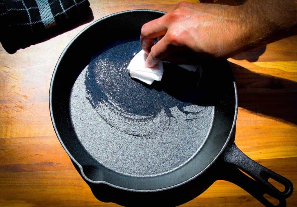 Brushing the cast iron pan with oil.