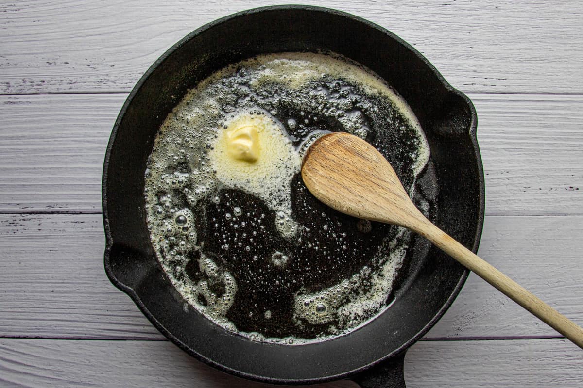 Melting the butter in the pan.