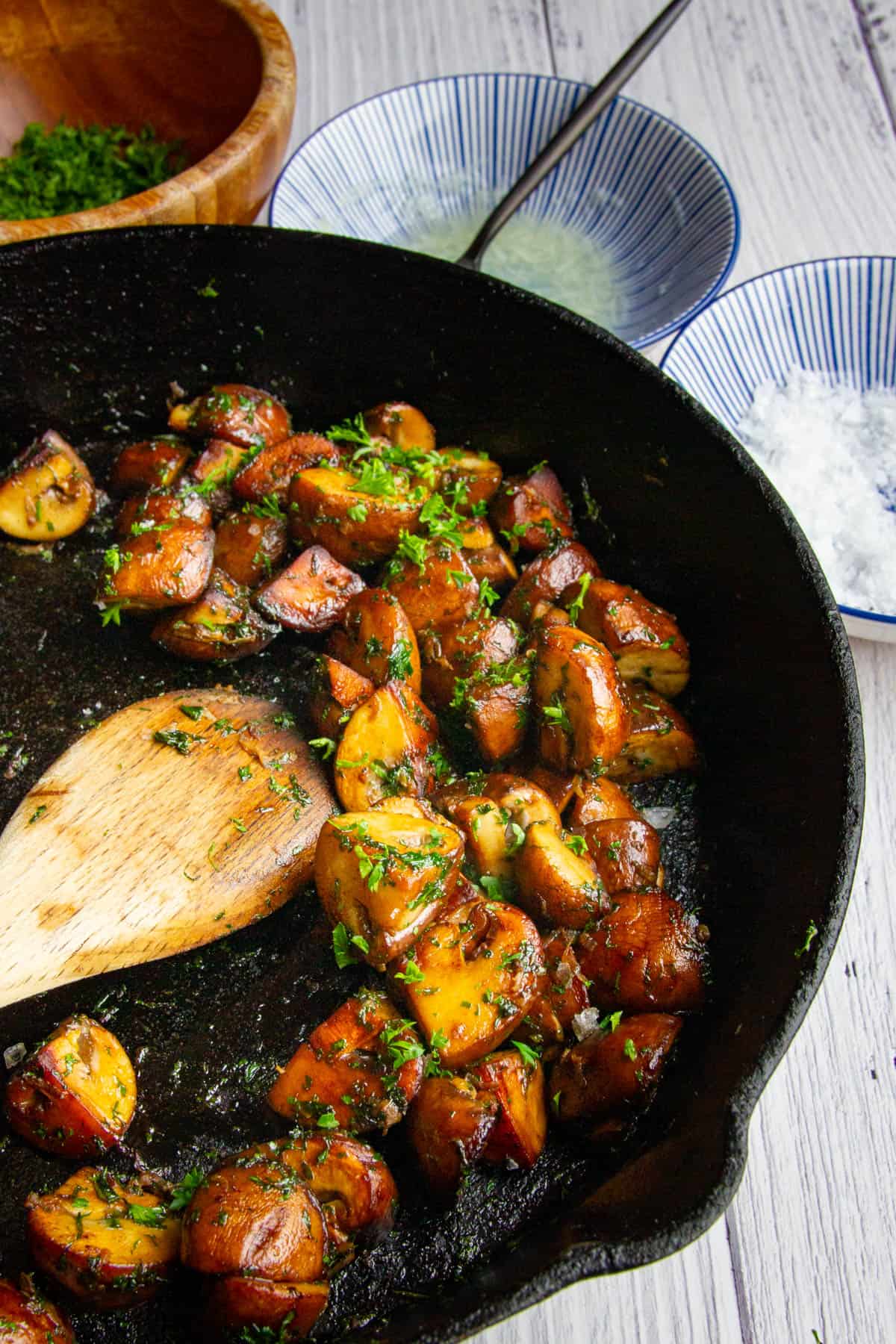 Cooking mushroom in a cast iron pan.