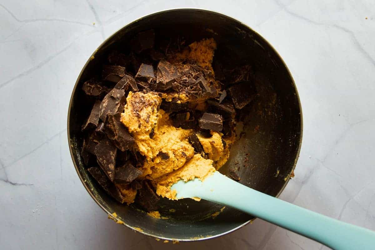 Mixing the chocolate chunks into the batter.