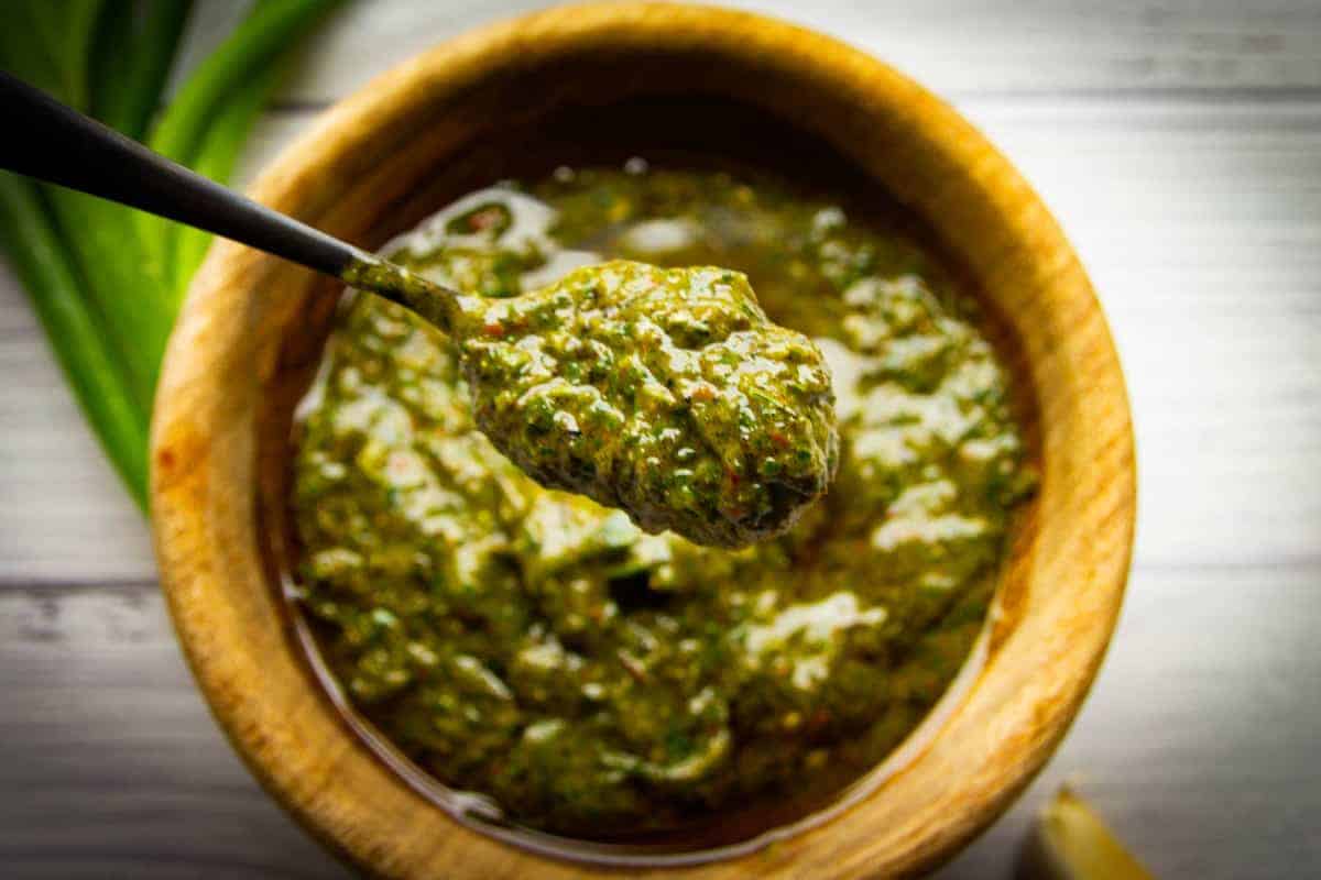 Green onion chimichurri in a bowl on a spoon.