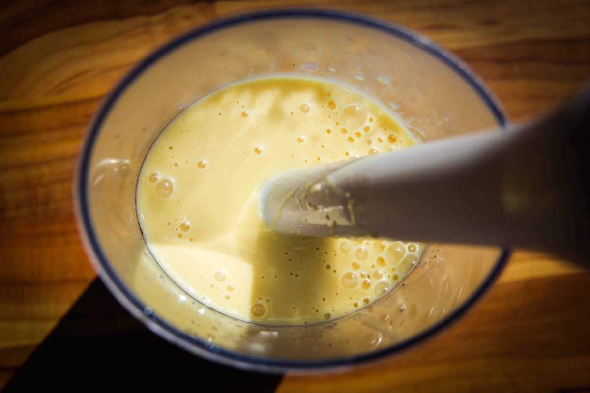 Blending the ingredients together with a hand blender.