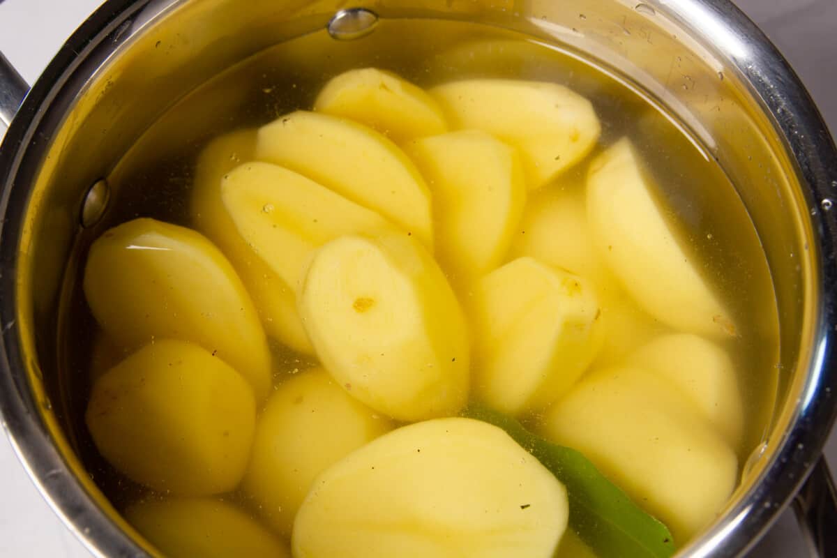 Peeled potatoes in a pot ready to be boiled.