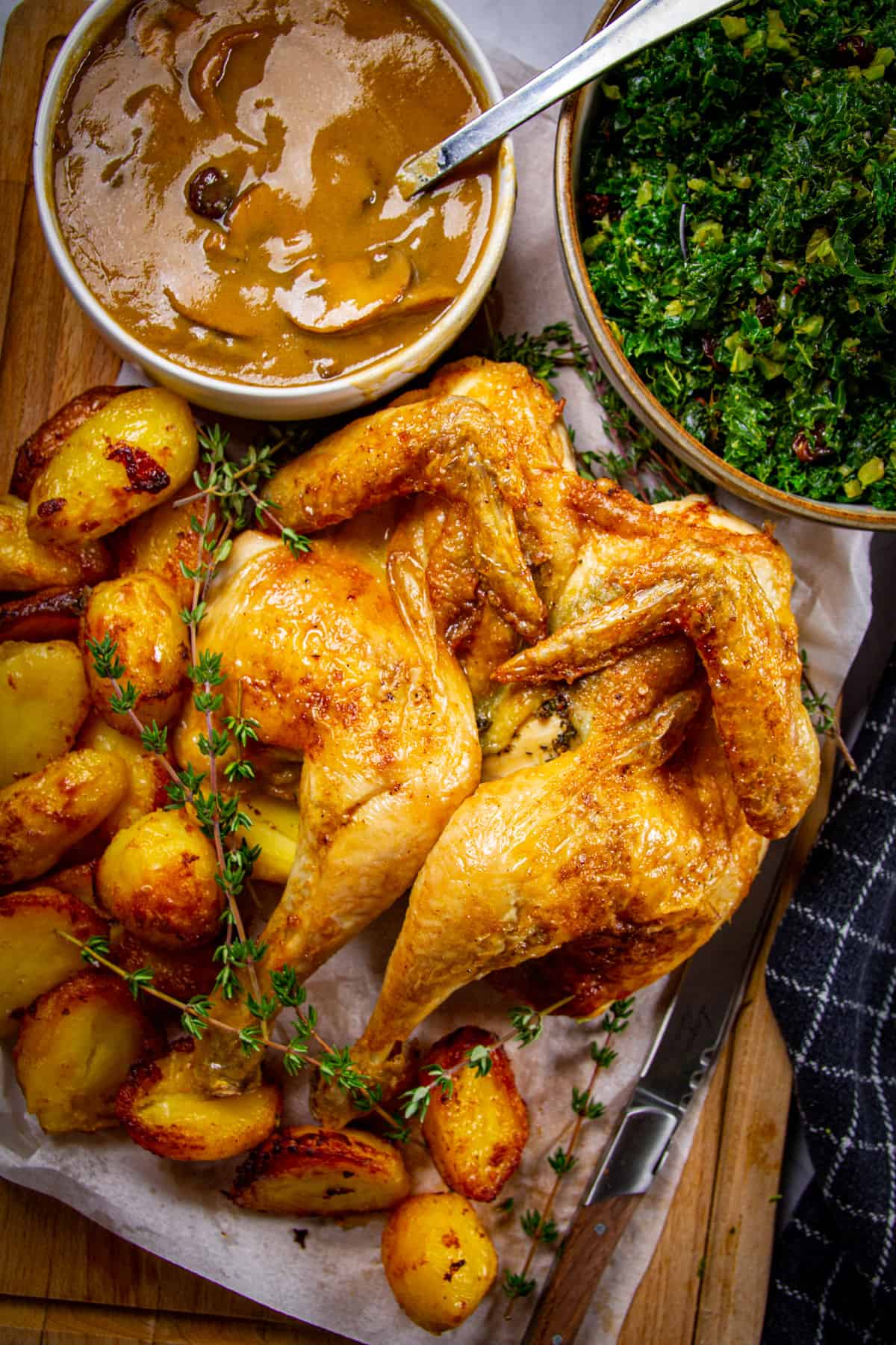 A spatchcock holiday chicken dinner with mushroom gravy and crispy potatoes.