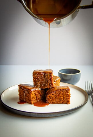 A sticky toffee pudding stack with salted caramel poured over top.