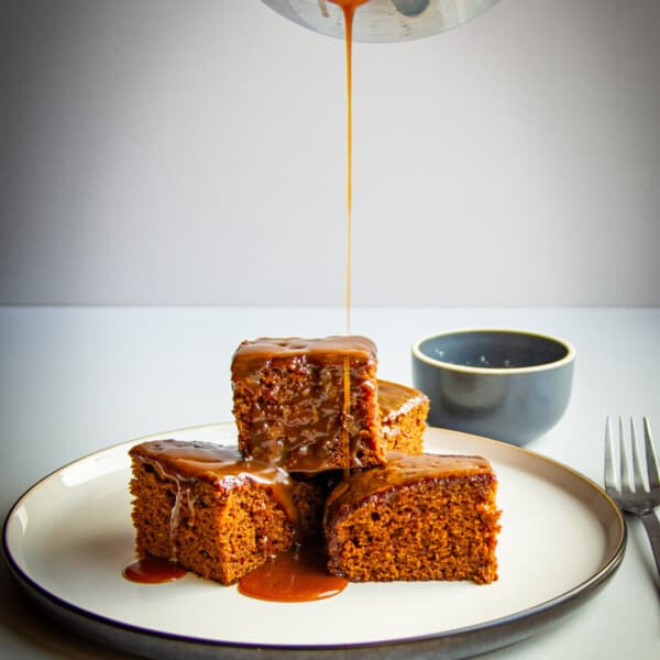 A sticky toffee pudding stack with salted caramel poured over top.