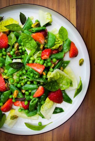 Strawberry pea and basil salad on a plate.