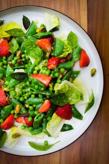 Strawberry pea and basil salad on a plate.