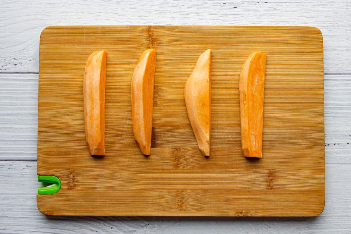 The sweet potato wedges on a cutting board.