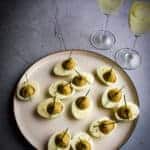 Truffled Deviled Eggs with two glasses of champagne.