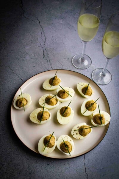 Truffled Deviled Eggs with two glasses of champagne.