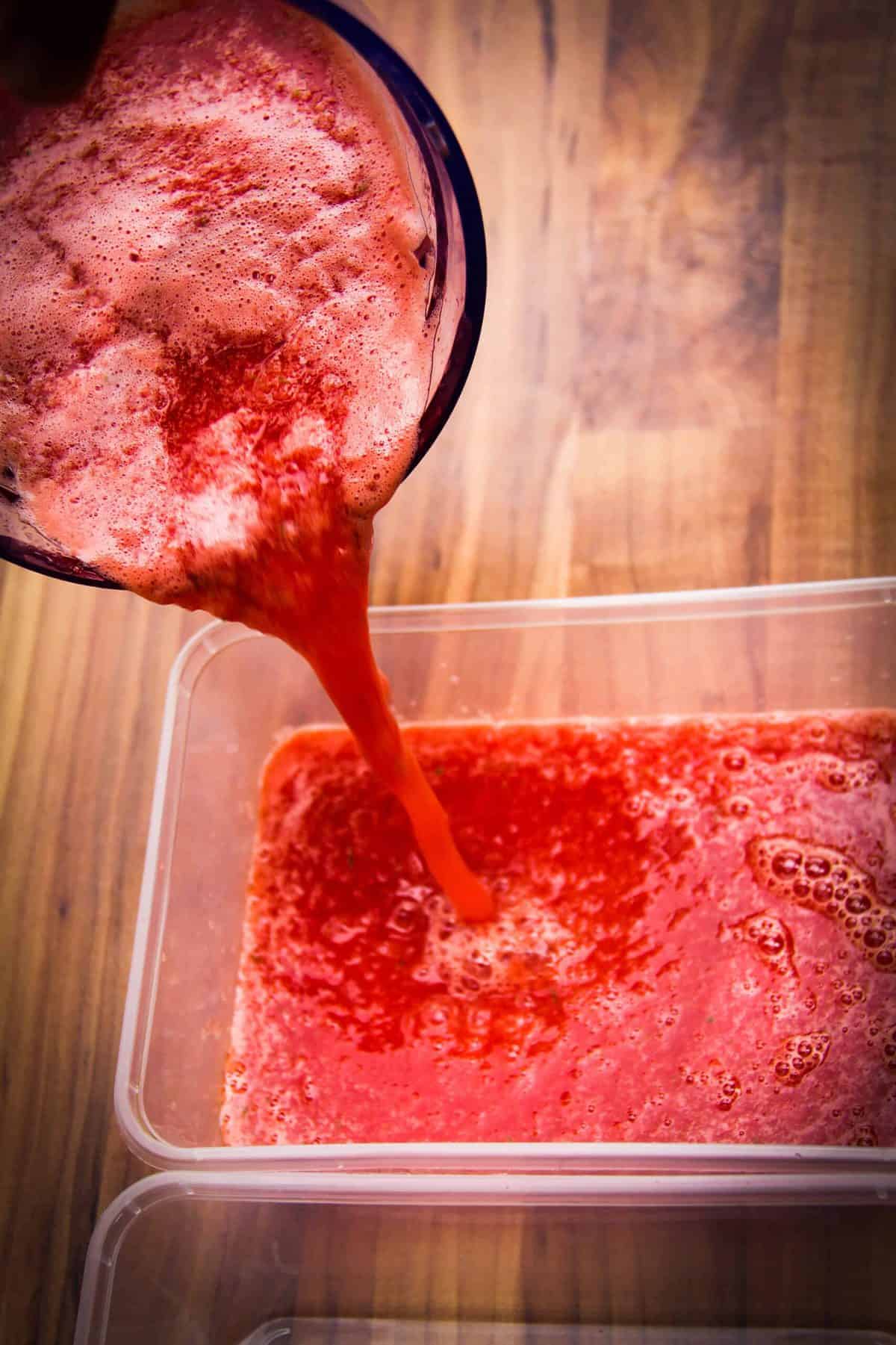 Pouring the granita into a container to freeze.