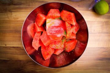 The watermelon, lime and vodka in a bowl ready to blend.