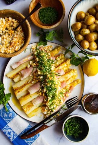 White asparagus with ham, egg, potato, chives, parsley and brown butter.