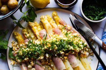 White asparagus with ham, egg, potato, chives, parsley and brown butter.