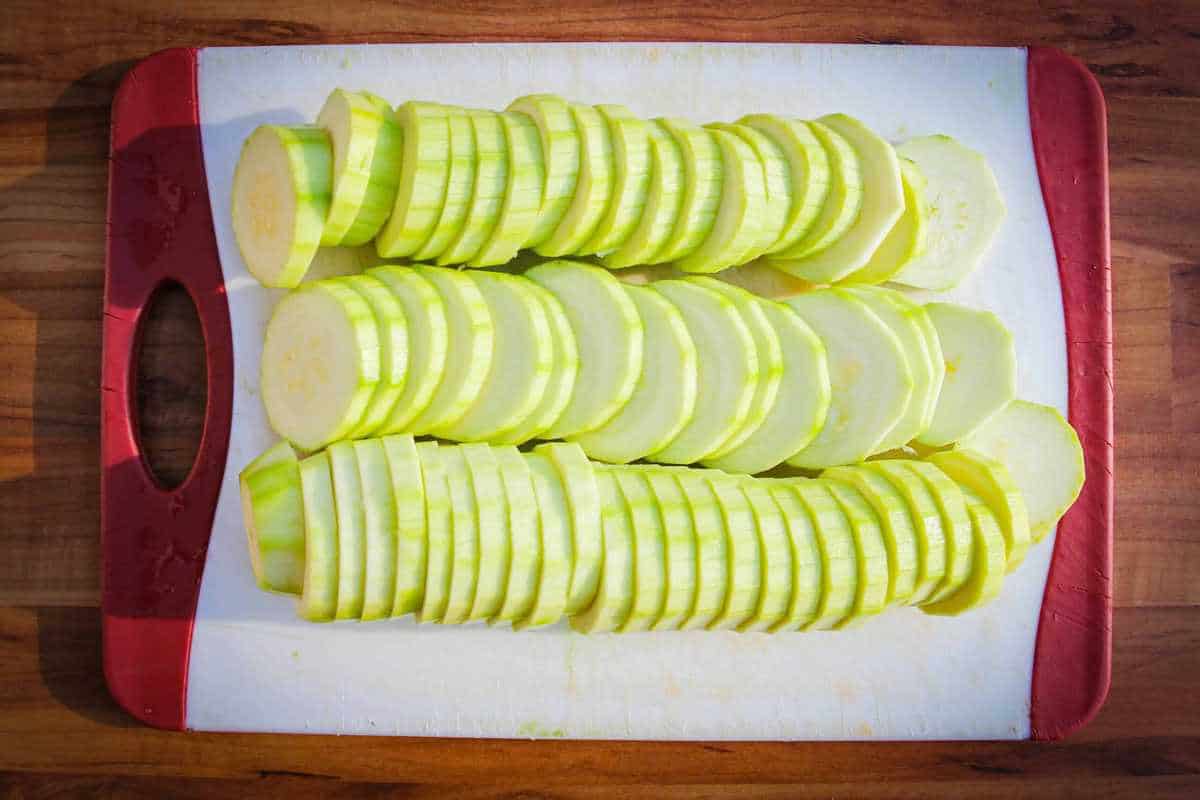 The sliced zucchini on a cutting board.