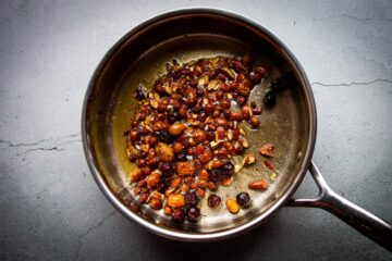 The brown butter, chili, almonds and raisins in a pan.