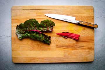 Cutting the rainbow chard stem out.