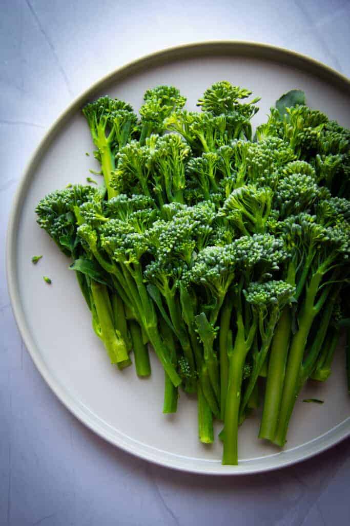 broccolette raw on a plate.