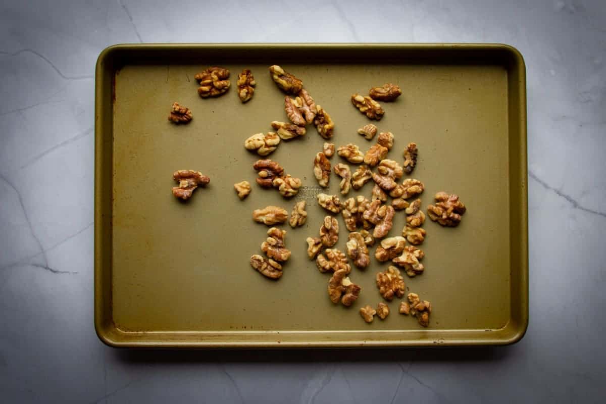 toasting the walnuts on a tray.