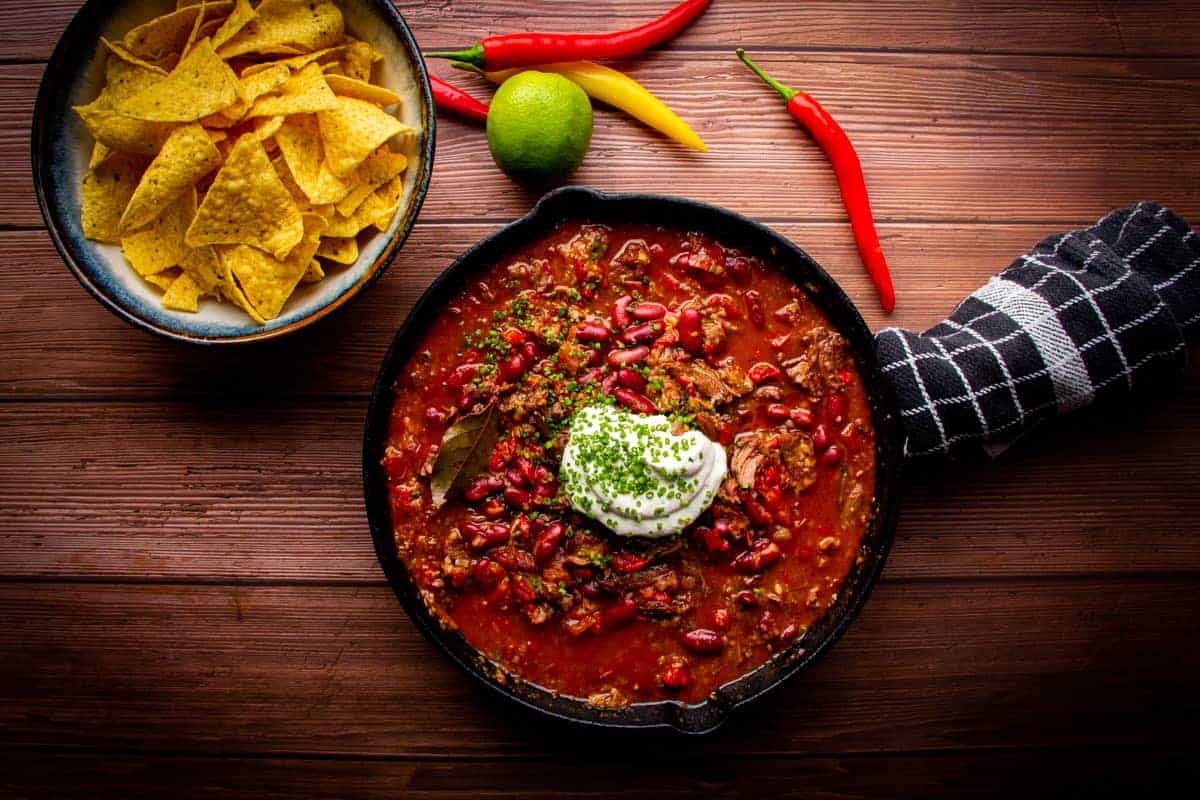 Short rib chili made in an instant pot with tortilla chips on the side.