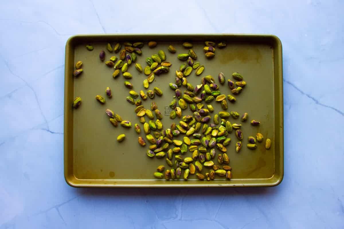 Toasting the pistachios on a tray.