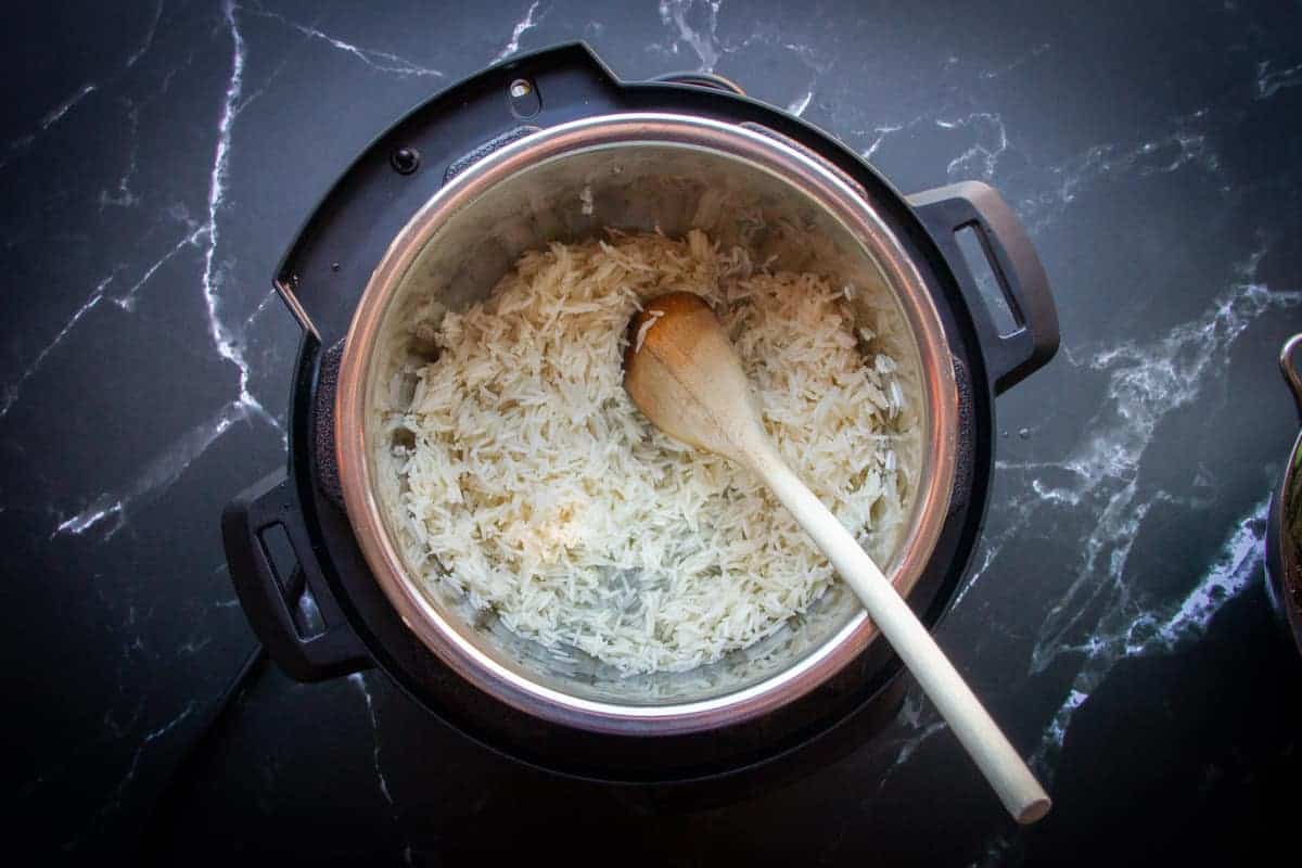 Frying the rice in the flavoured oil.