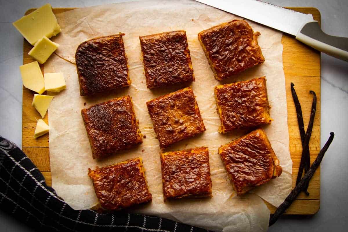 The finished vanilla brownies cut into 9 squares on a board.