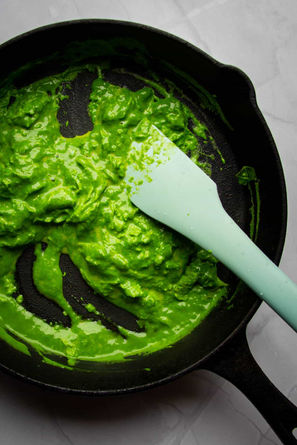 Green eggs in the pan made using a spinach puree.