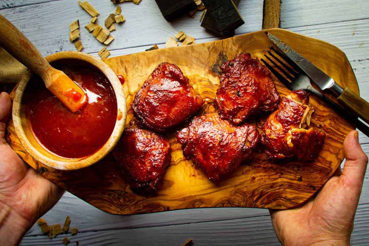 Smoked-chicken-thighs-ready-on-a-board-with-bbq-sauce