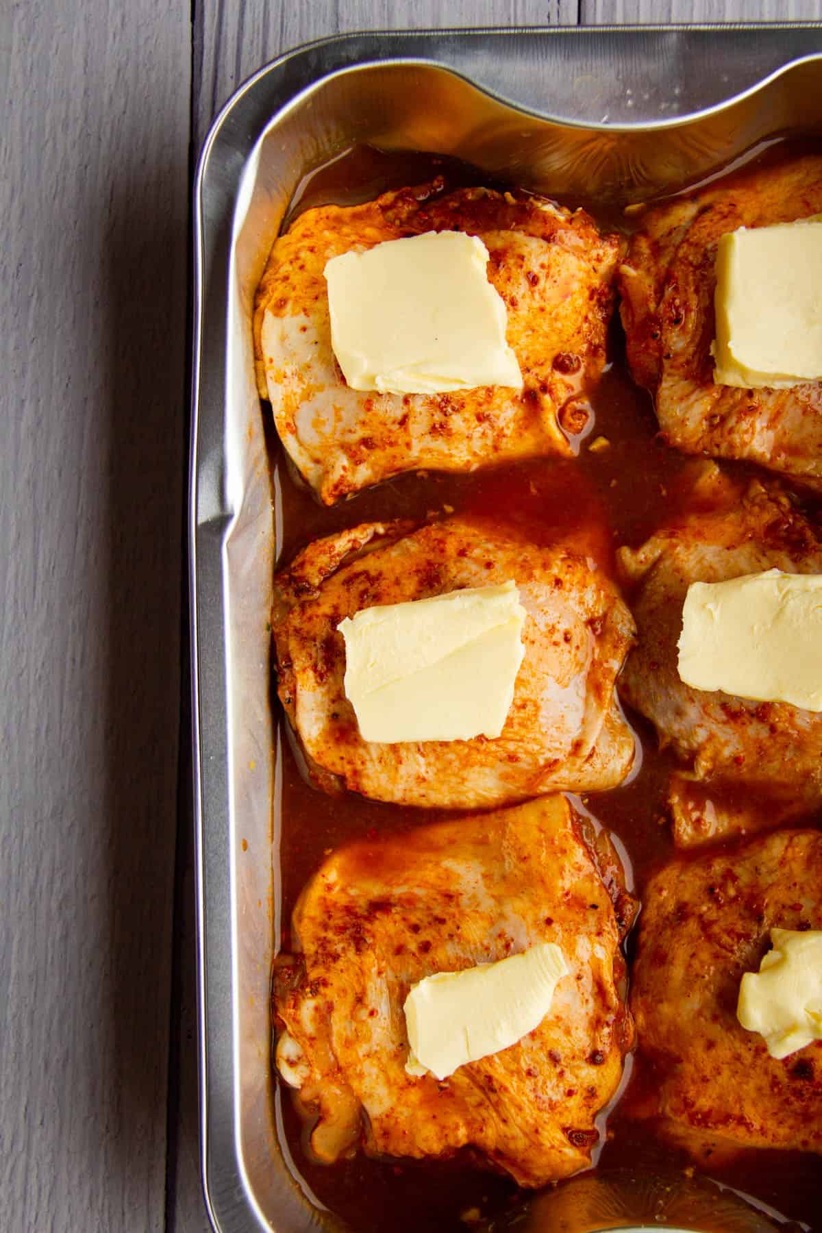 Chicken-thighs-ready-to-be-smoked-with-butter-on-top